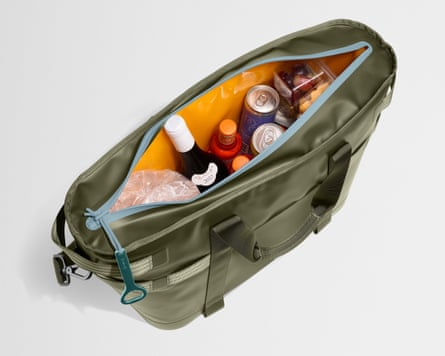 green cooler tote filled with drinks and fruit