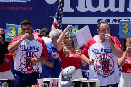 Joey Chestnut (right) and James Webb get eating at the Fourth of July contest.