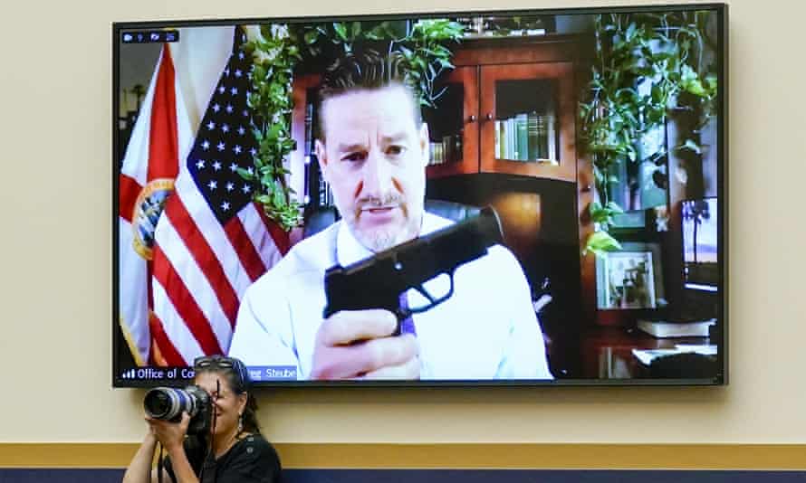 Greg Steube, a Republican congressman from Florida, brandishes one of his personal collection of weapons, during a House hearing on gun reform.