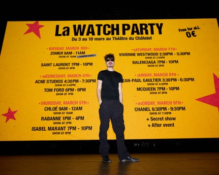 Medini stood in front of a backdrop detailing the watch party schedule