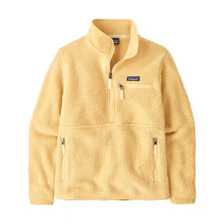 A butter yellow fleece. It has a high neck with a short zip. There is a zip pocket on the left pocket and a zip pocket on either side of the torso.