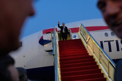 Keir Starmer waving upon his arrival at an airport in Beijing.