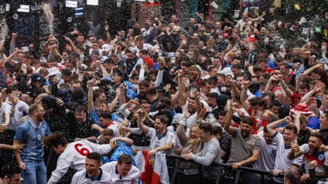 Fans throw their drinks in celebration as England score their first goal of the World Cup – video