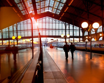 Two people walking along a platform at the Gare du Nord station