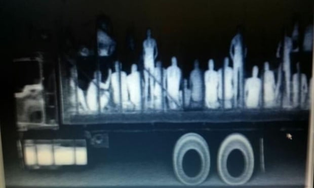 Immigrants from Central America, Nepal and Bangladesh are seen in a trailer truck after being detected by police X-ray equipment in Mexico.