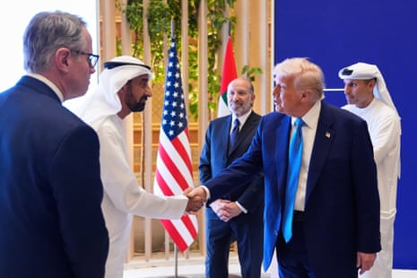 President Donald Trump is greeted by a participant as he attends a business meeting at Qasr Al Watan, in Abu Dhabi, the United Arab Emirates.