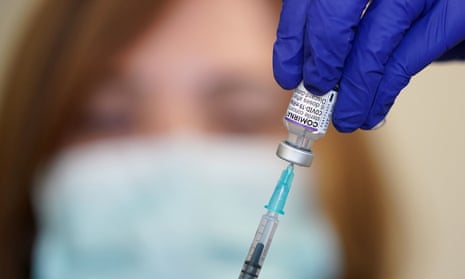 Nurse Heather Esmer draws a syringe before administering a Covid-19 vaccine booster at Birkenhead Medical Building in Birkenhead, Merseyside