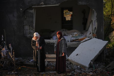 Two women inspect a house destroyed by an Iranian missile strike in Zarzir, northern Israel, on Friday