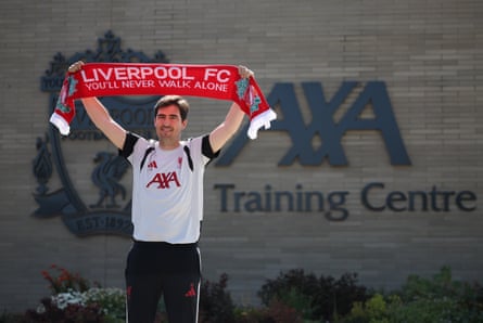 Iraola holds up a Liverpool scarf