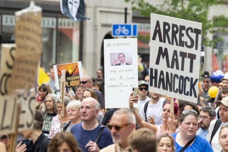 Anti-Hancock placards being waved by protesters in London yesterday attending an anti-lockdown ‘freedom march’.