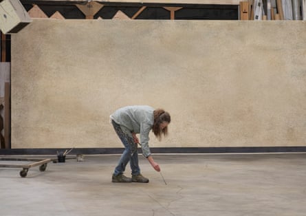 Scenic artist Kerry Jarrett paints the stage floor