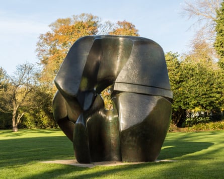 An abstract statue by Moore in bright parkland