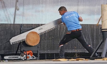 Brad De Losa gets stuck into a log with a massive saw.