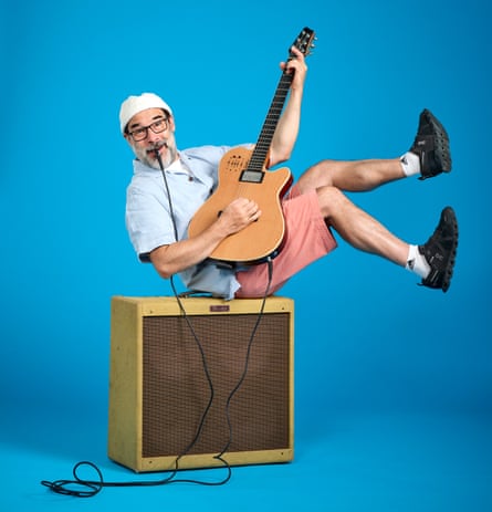 Adam Buxton poses with guitar