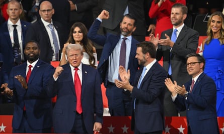People cheer as man in suit accepts applause