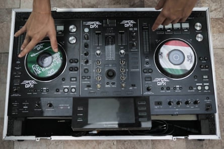 Dj Kaio VDM - who plays at favela raves named after Acapulco and Saudi Arabia - shows off his customized mixing system at his home in Rio.