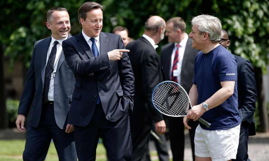 John Bercow in shorts and T-shirt jokes with David Cameron and aides in suits.