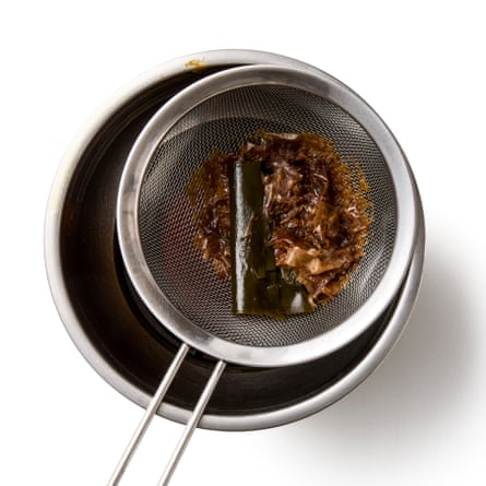 Straining the sauce – fishing out the seaweed from the brown water