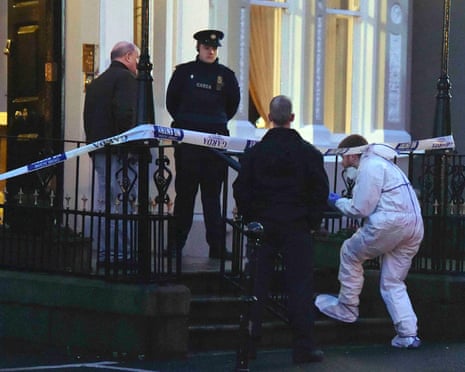 Police and forensic officers attend the scene of a shooting at the Regency Hotel in Dublin