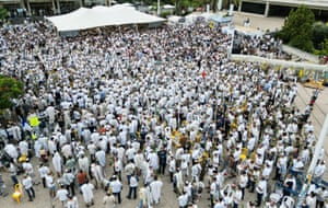 An aerial shot of a group of people wearing white