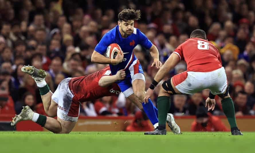 Romain Ntamack of France is tackled by Taulupe Faletau of Wales.
