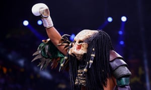 Michael Hunter enters the ring in a Predator costume