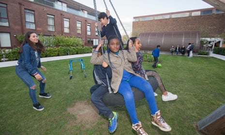 Children from Wren Mews playing in the garden at Baylis Old School development they were previously barred from using.