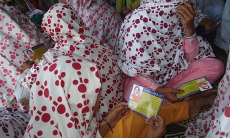 Women read safe abortion manuals, translated in Urdu by Aware Girls, at a community meeting in Swabi in northwest Pakistan.