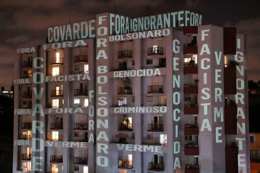 Slogans denouncing Jair Bolsonaro’s response to the pandemic are projected on a building in São Paulo in Brazil