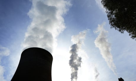 Steam billows from the cooling towers of a coal-fired power station