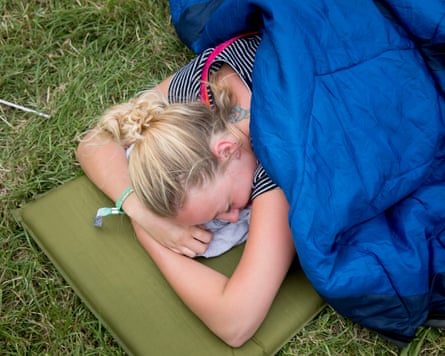 A festivalgoer trying to get some extra sleep.