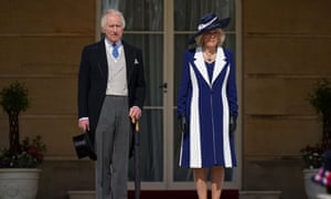 Charles and Camilla standing side by side to meet guests attending the Garden Party at Buckingham Palace on 3 May.