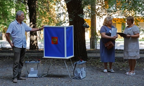 Electoral commission members wait for voters at a mobile polling station in Donetsk, Russian-controlled Ukraine, on Saturday during regional elections held by Russian-installed authorities