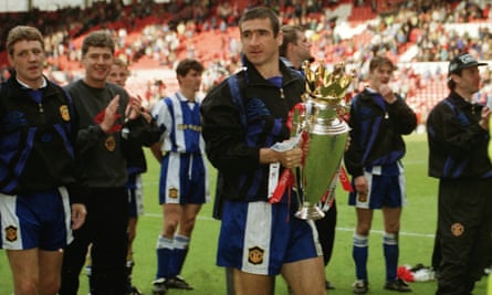 Eric Cantona and his Manchester United team-mates celebrate with the Premier League trophy in 1996.
