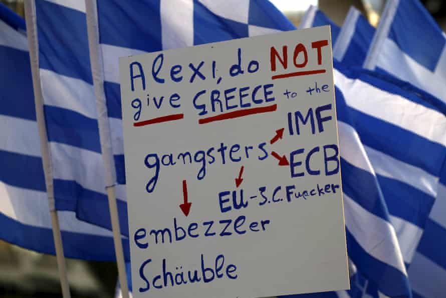 Protesters hold a banner in front of the parliament during a pro-government rally calling on Greece’s European and International Monetary creditors to soften their stance in the cash-for-reforms talks in Athens, June 17, 2015. The Greek central bank warned on Wednesday that the country risked a painful exit from the euro and ultimately even the European Union if Athens and its creditors do not strike a swift aid-for-reforms deal. REUTERS/Yannis Behrakis