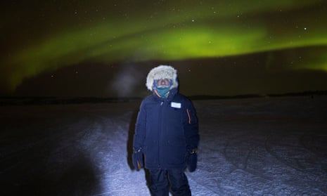 Dean Yibarbuk from Warddeken land management in West Arnhem in minus 40 degree temperature outside Yellowknife checking out the Aurora Borealis. Indigenous rangers visit Yellowknife. Canada.