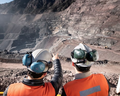 Two men stand at Anglo American’s El Soldado copper mine in Chile