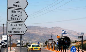 Israeli security forces guard a bus station at the Tapuach junction near the West Bank city of Nablus