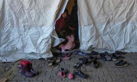 A Syrian child looks on from inside a tent used as a shelter in Gaziantep