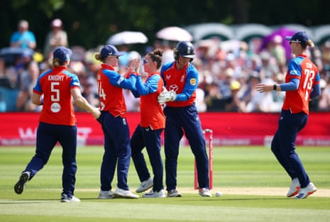 England's Linsey Smith celebrates after taking the wicket of New Zealand's Melie Kerr with teammates.