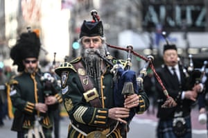 Men playing bagpipes in a parade