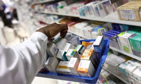 A pharmacist collects medications for prescriptions