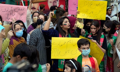 Supporters of Imran Khan hold placards that read ‘Save Pakistan, save the constitution’ during a protest outside his house in Lahore, Pakistan.