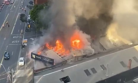 Fire erupts from the roof of a factory