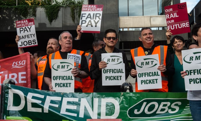 Striking members of the RMT and TSSA trade unions join the picket line at Euston station.