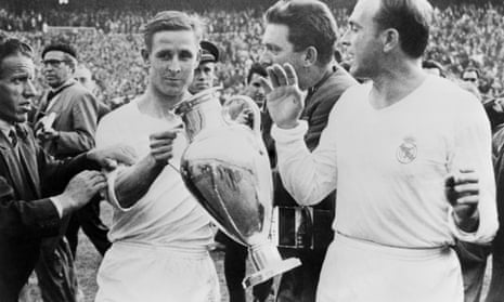 Raymond Kopa holds the European Cup after Real Madrid’s 2-0 victory over Fiorentina in the 1957 final at the Santiago Bernabéu stadium in Madrid. Colleague Alfredo Di Stefano looks on.