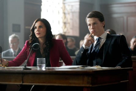 Two women in a courtroom setting wearing smart suits