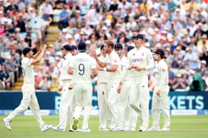 Stuart Broad celebrates with teammates after taking the wicket of Tom Latham.