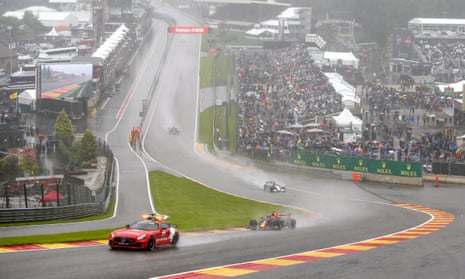 The safety car leads Max Verstappen, George Russell and Lewis Hamilton around Spa
