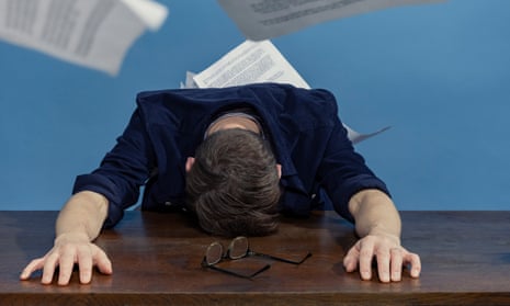 Tim Jonze, face down on a desk, surrounded by sheets of typed paper